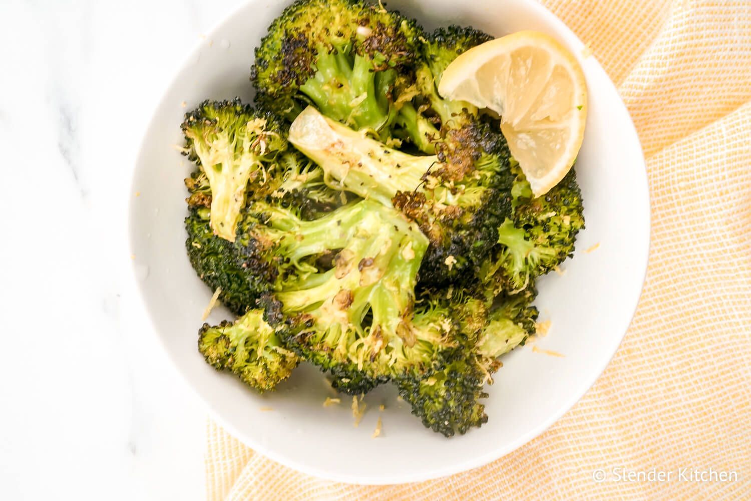 Crispy Baked Broccoli Baked broccoli with garlic and lemon in a bowl.
